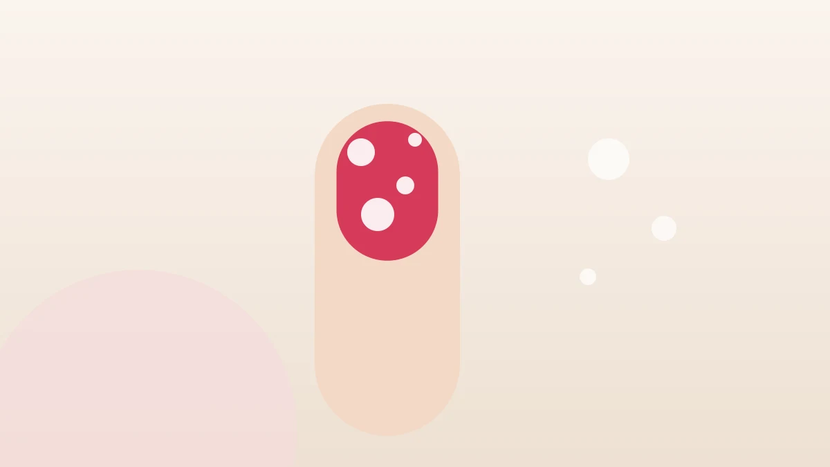 A nail painted coral with small air bubbles trapped in the polish