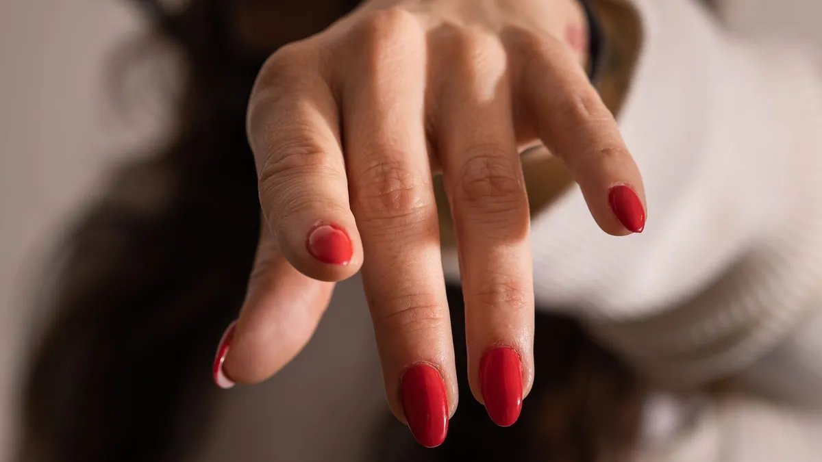 Soft coral gradient with three minimalist nail polish bottle shapes