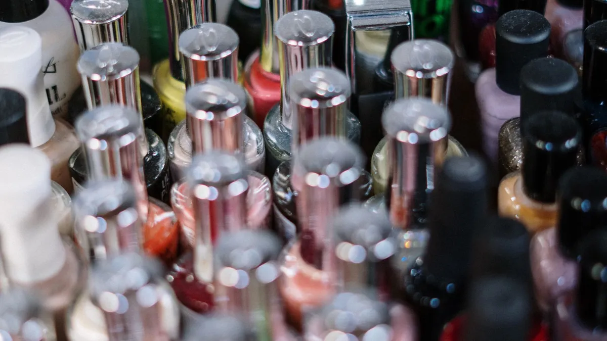 A rack of assorted nail polish bottles in many colors