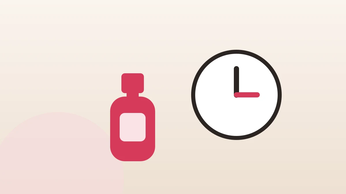 A coral nail polish bottle beside a clock face